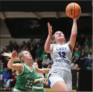  ?? (NWA Democrat-Gazette/J.T. Wampler) ?? Bergman’s Maddi Holt (12) goes up for a shot in front of Valley Springs’ Eliza Drewry on Saturday during the Lady Panthers’ 55-28 victory for the 3A-1 regional tournament title in West Fork.