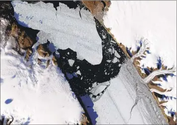  ?? JESSE ALLEN & ROBERT SIMMON NASA EARTH OBSERVATOR­Y VIA AP ?? Greenland’s Petermann Glacier cracks up in 2010. Scientists say the glacier is melting faster than expected.