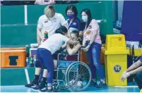 ??  ?? MADDIE MADAYAG of Choco Mucho sits on a wheelchair after hurting her left knee in their best-ofthree bronze medal match against Petro Gazz Wednesday night (PVL Media Bureau)