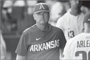  ?? The Associated Press ?? STOIC VAN HORN: Arkansas coach Dave Van Horn is shown in the dugout before the Razorbacks game against South Carolina at Monday’s NCAA super regional final in Fayettevil­le. Arkansas will make its ninth College World Series appearance this weekend, the...