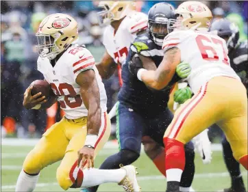  ?? STEPHEN BRASHEAR - GETTY IMAGES ?? Running back Carlos Hyde of the 49ers rushes against the Seahawks during the second quarter Sunday. Hyde put up 124 yards on the ground against Seattle, but he and the 49ers are still looking for their initial touchdown of the season.