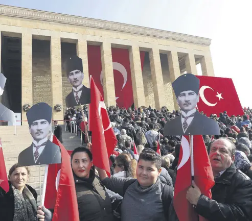  ??  ?? People carry Turkish flags and pictures of Atatürk in front of his mauseloum, Anıtkabir, Ankara, Nov. 10.