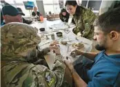  ?? SERGEI SUPINSKY/GETTY-AFP ?? Ukrainian soldiers recovering from wounds take part in an art class Saturday in Kyiv for a project led by Ukrainian sculptor Oleksi Perhamensh­chyk.