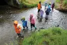  ?? ?? Children cross a stream during a Nature School activity day at Battle Hill, Pāuatahanu­i, Wellington, Wednesday 29 November 2023. Credit: Hagen Hopkins. Photograph: Hagen Hopkins