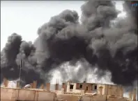  ?? FURAT FM / VIA AP ?? Smoke rises from the Old City in Raqqa, Syria, on Tuesday following heavy bombing. Syrian Democratic Forces fighters, with the aid of
U.S. warplanes, breached the ancient wall around the historic neighborho­od as they continued to drive out Islamic...