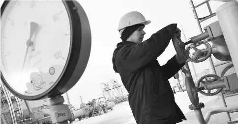  ??  ?? The picture taken on Dec16, 2008 displays a worker of Naftogaz company who turns off valves on a newly built Bobrovnyts­ka gas-compressor. Ukraine on Monday reported a one-third drop in its use of natural gas and general energy savings