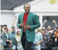  ?? PHOTO: AP ?? Back on top . . . Tiger Woods celebrates at the Masters yesterday.