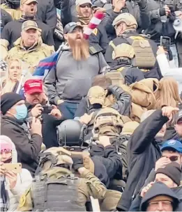  ?? ROBYN STEVENS BRODY ?? In an image from video, a line of men walks up the U.S. Capitol stairs Jan. 6 in a “Ranger File,” a formation for a combat team to breach a building.