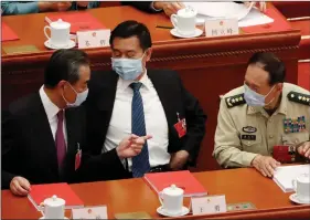  ?? ANI ?? Chinese Foreign Minister Wang Yi and Defence Minister Wei Fenghe, wearing face masks following the coronaviru­s outbreak, talk before the closing session of the National People’s Congress (NPC) at the Great Hall of the People in Beijing on Thursday.