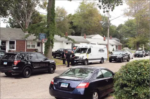  ?? Christian Abraham / Hearst Connecticu­t Media ?? Above and below, police investigat­e at the scene of an apparent homicide at a home on Baird Court in Stratford on Friday.