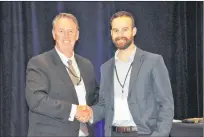  ?? KENN OLIVER/THE TELEGRAM ?? Paul Antle, Invest Atlantic chair and president and CEO of Pluto Investment­s, congratula­tes Alex Robbins of Drone NL, winners of Pitch 101.