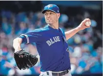  ?? NATHAN DENETTE THE CANADIAN PRESS ?? Blue Jays starting pitcher J.A. Happ pitches against the Atlanta Braves during the ninth inning in Toronto on Wednesday afternoon. Happ pitched 8 1/3 innings, allowing just six hits, no walks and four runs while striking out eight to pick up the victory.