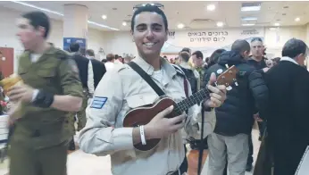  ??  ?? LONE SOLDIER Ron Volkmar, 20, plays the ukulele and also makes instructio­nal videos for the air force.