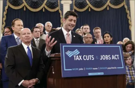  ?? J. SCOTT APPLEWHITE — THE ASSOCIATED PRESS ?? Speaker of the House Paul Ryan, R-Wis., joined at left by House Ways and Means Committee Chairman Kevin Brady, R-Texas, emphasizes the need for the changes provided in the GOP’s far-reaching tax overhaul, the first major revamp of the tax system in...