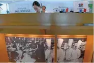  ??  ?? Floor staff prepare for lunch opening hours at the “Brasserie Paul Bocuse Le Musee”.