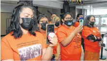  ?? JOE GIBBONS • THE TELEGRAM ?? Wearing orange T-shirts to pay tribute to the 215 Indigenous children whose remains were recently discovered at a former residentia­l school in Kamloops, B.C., members of the Innu nation from Labrador and across the province listen to the announceme­nt at the Confederat­ion Building in St. John’s on Thursday afternoon for the Commission of Inquiry into the Treatment, Experience­s and Outcomes of Innu in the Child Protection System.