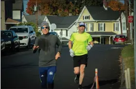  ?? STEVE SCHALLENKA­MP PHOTO ?? Charles Gassenheim­er of Woodstock, left, and Jason Taylor of New Paltz, right, race to the finish line in the grueling Morning Star Run for Shelter 5K in Kingston, N.Y., on Oct. 22, 2022.