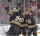  ?? MADDIE MEYER/GETTY IMAGES ?? David Pastrnak (88) celebrates with his Bruins teammates after scoring in overtime Saturday against the Maple Leafs in Game 7.