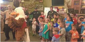  ?? ALEXIS EGELAND/THE REPUBLIC ?? Kids and local law enforcemen­t dance with Eddie Eagle while learning about gun safety.