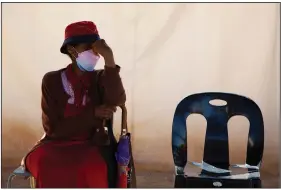  ?? (AP/Denis Farrell) ?? A woman waits in a queue to be screened for COVID-19 at a testing centre in Soweto, South Africa, Wednesday.