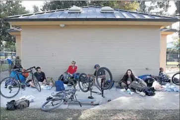  ?? Photograph­s by Nancee E. Lewis ?? HOMELESS PEOPLE rest at an El Cajon park where, this weekend, an event provided food and toiletries.