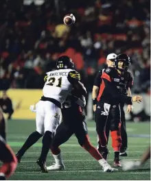  ?? SEAN KILPATRICK THE CANADIAN PRESS ?? Trevor Harris throws a pass against the Tiger-Cats last Friday in Ottawa.