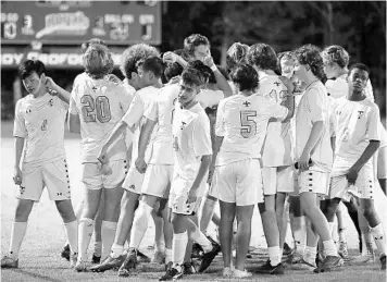  ?? STEPHEN M. DOWELL/ORLANDO SENTINEL ?? Trinity Prep players huddle before a boys soccer game at The First Academy on Tuesday.