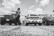  ?? Michael Ciaglo / Houston Chronicle file ?? Sterling McCall Toyota’s Auggie Mathis points out vehicles in the dealership’s Val-U-Line area.