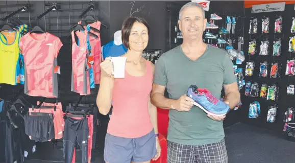  ?? RUNNING BUSINESSES: Su Lora and Paul Day in their sports shop in Stagpole St, West End. ??