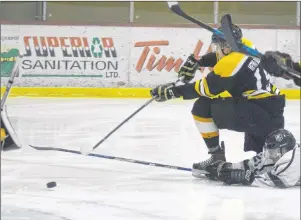  ?? JASON MALLOY/THE GUARDIAN ?? Sherwood-Parkdale Metros forward Owen Arsenault fires a backhand shot on Tri-County Rivercats goalie Josh Simpson as Rivercats defenceman Dominik Reid dives to try to break up the scoring chance Friday in Crapaud. The Metros won the round-robin game in...