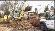  ?? Tyler Sizemore / Hearst Connecticu­t Media ?? Stamford town employees work to collect leaves on Terrace Avenue in Stamford on Wednesday.