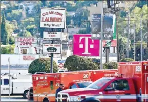  ?? ROBYN BECK/AFP ?? Police and members of the Los Angeles Fire Department are seen after a suspect barricaded inside a supermarke­t in Silverlake, Los Angeles, on July 21.