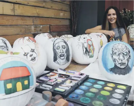  ??  ?? Face painting artist Carma Conroy painting pumpkins ahead of Halloween