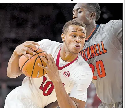  ?? NWA Democrat-Gazette/J.T. WAMPLER ?? Arkansas guard Daniel Gafford drives to the basket against Bucknell’s Nana Foulland during Sunday’s victory at Walton Arena in Fayettevil­le. The Razorbacks won their first two games of the season by at least 28 points for the first time since the...