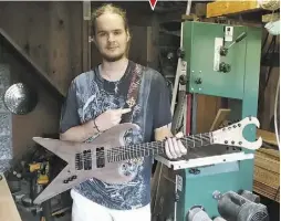  ?? BY ALEX FORTE ?? Oliver Herron and his custom made guitar.