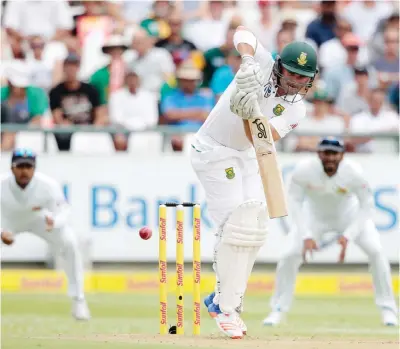  ?? — AFP ?? CAPE TOWN: South African batsman Dean Elgar plays a shot during the second Test between South Africa and Sri Lanka yesterday at Newlands Cricket Stadium in Cape Town, South Africa.