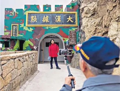  ?? ?? People take photos at the entrance of a former military fort last week in Nangan, on the Matsu archipelag­o, Taiwan