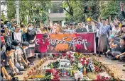  ?? AP ?? People shout slogans and light candles to honour Chit Min Thu where he was shot during a protest in Yangon.