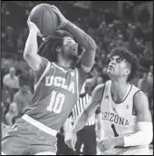  ?? Associated Press ?? HANDS UP UCLA’s Tyger Campbell (10) looks to pass as Arizona State’s Remy Martin (1) defends during the first half of an NCAA college basketball game on Thursday in Tempe, Arizona.