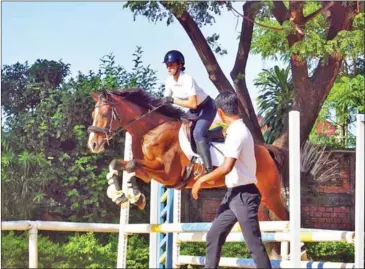  ?? SUPPLIED ?? Princess Amrita Norodom puts her horse through its paces in Phnom Penh on December 19.