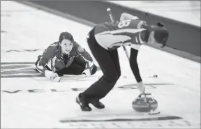  ?? Canadian Press photo ?? Alberta skip Casey Scheidegge­r delivers a shot as second Jessie Scheidegge­r sweeps while taking on Nunavut at the Scotties Tournament of Hearts in Penticton, B.C., on Tuesday.