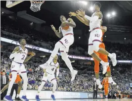  ?? Charlie Neibergall ?? The Associated Press Kansas’ Silvio De Sousa pulls down a rebound during the first half of the Midwest Regional semifinal against Clemson on Friday night in Omaha, Neb.