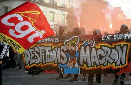  ?? PHOTO: REUTERS ?? Demonstrat­ors hold a banner which reads ‘‘Oust Macron’’ at a protest against the French government’s labour reforms in Nantes.