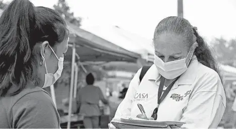  ?? FEDERICA NARANCIO/AP ?? A health promoter from CASA tries to enroll Latinos as volunteers to test a potential COVID-19 vaccine at a farmers market in Takoma Park, Maryland.