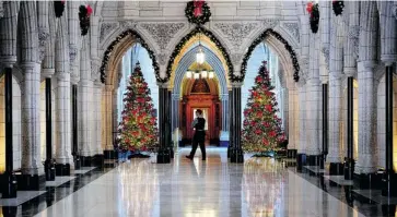  ?? SEAN KILPATRICK/THE CANADIAN PRESS ?? Public Works puts up grand trees each year in the Parliament Buildings, enjoyed regularly, one has to think, by MPs and their staff, as well as various RCMP officers, commission­aires, reporters, lobbyists, maintenanc­e workers and the like.