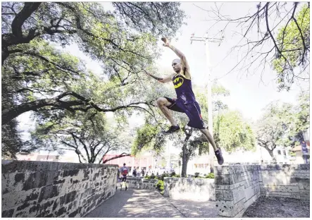  ?? RICARDO B. BRAZZIELL PHOTOS / AMERICAN-STATESMAN ?? Josh Grant demonstrat­es his ninja warrior skills by scaling a wall with one jump on the campus of The University of Texas. Grant, or Ninja Josh, as
he is known, is big into the local ninja scene. He’s been on “American Ninja Warrior” three times.