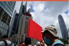  ??  ?? Pro-china supporters hold a placard on their way to protest at the U.S. Consulate in Hong Kong