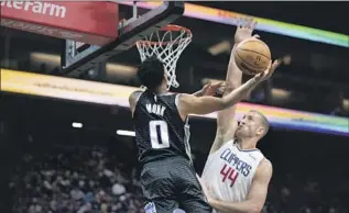  ?? JOSÉ LUIS VILLEGAS Associated Press ?? KINGS GUARD Malik Monk attacks the basket and tries to score over Clippers center Mason Plumlee, who had 13 points and eight rebounds. Monk finished with 13 points and eight assists.