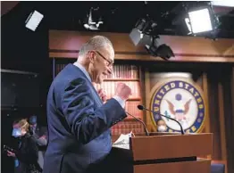  ?? J. SCOTT APPLEWHITE AP ?? Senate Majority Leader Chuck Schumer, D-N.Y., praises his Democratic Caucus at a news conference after the Senate narrowly approved a $1.9 trillion relief bill.