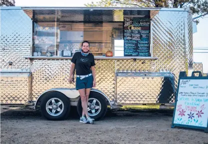 ?? KASSIJACKS­ON PHOTOS/HARTFORD COURANT ?? Lizanne Searing, owner of Lizzie’s Curbside food truck and catering, says the past six months have been overwhelmi­ng. Searing vends year-round at UConn, and restrictio­ns also upended much of her summer event schedule.